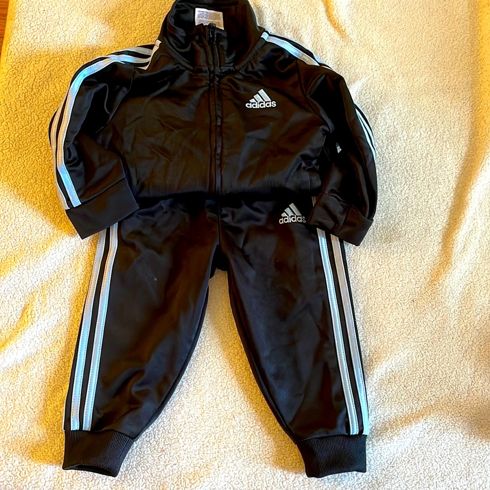12 months Adidas track suit worn once!!!! Black and baby blue lining zip up